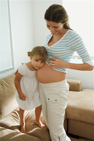 Girl Listening to Pregnant Mother's Belly Foto de stock - Con derechos protegidos, Código: 700-01646277