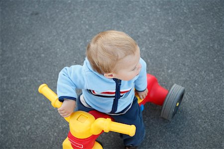 Baby Playing on Tricycle Stock Photo - Rights-Managed, Code: 700-01670785