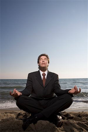 Businessman Meditating on Beach Stock Photo - Rights-Managed, Code: 700-01694497