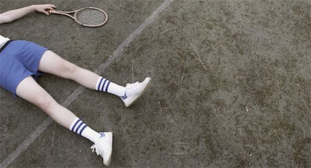 View of Tennis Player's Legs Lying on Tennis Court Photographie de stock - Rights-Managed, Code: 700-01695261