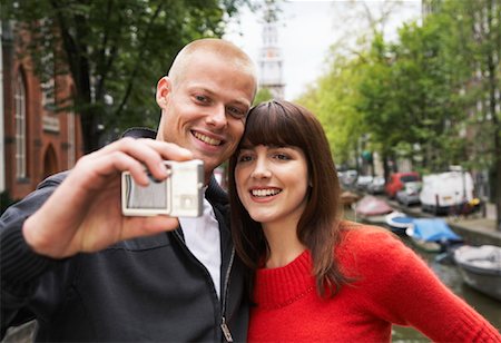 snapshot - Couple Taking Self Portrait by Canal, Amsterdam, Netherlands Stock Photo - Rights-Managed, Code: 700-01695511