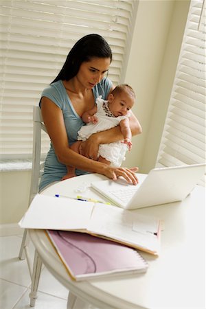 Mother Working at Laptop Computer and Holding Baby Stock Photo - Rights-Managed, Code: 700-01695593