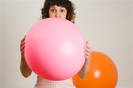 Woman Blowing Up Balloon Foto de stock - Con derechos protegidos, Código: 700-01716197