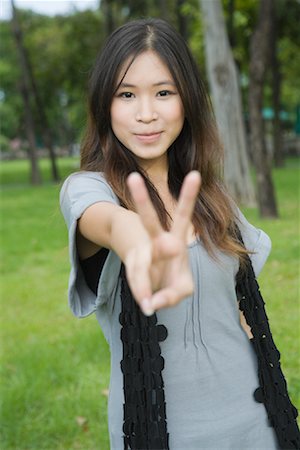 Woman Giving Peace Sign Stock Photo - Rights-Managed, Code: 700-01716685