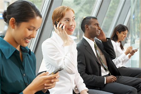 female worker on phone - Business People in Foyer with Electronic Organizers, Toronto, Ontario, Canada Stock Photo - Rights-Managed, Code: 700-01764207