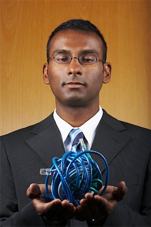 problème d'ordinateur - Homme d'affaires avec boule de câbles Ethernet Photographie de stock - Rights-Managed, Code: 700-01764257