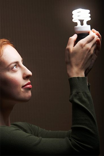 Woman Holding Energy Efficient Light Bulb Stock Photo - Premium Rights-Managed, Artist: Masterfile, Image code: 700-01764273