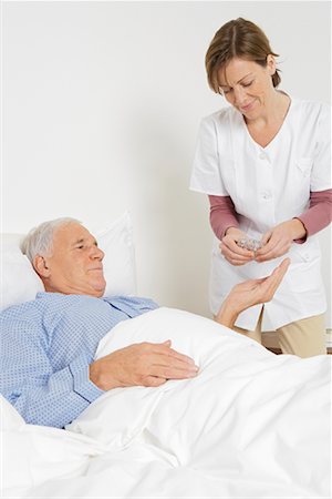 pictures of white men in hospital bed - Nurse Giving Medication to Patient Stock Photo - Rights-Managed, Code: 700-01764485