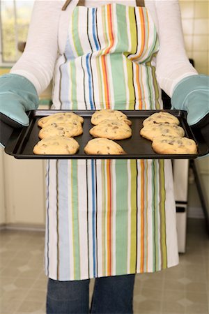 sweet lady cooking - Woman Holding Tray of Freshly Baked Cookies Stock Photo - Rights-Managed, Code: 700-01787509