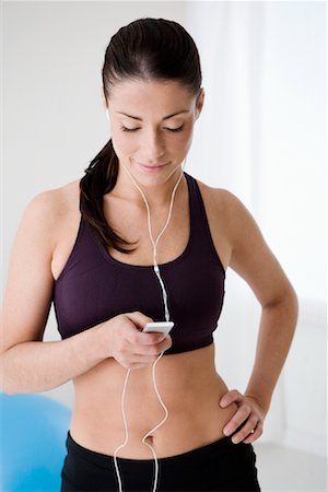 Woman Wearing Work Out Clothes and Looking at iPod Stock Photo - Rights-Managed, Code: 700-01787594