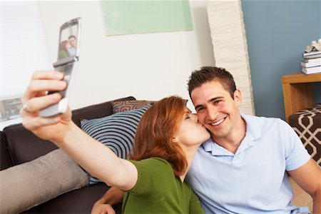 Couple in Living Room with Laptop Computer Foto de stock - Con derechos protegidos, Código: 700-01787650