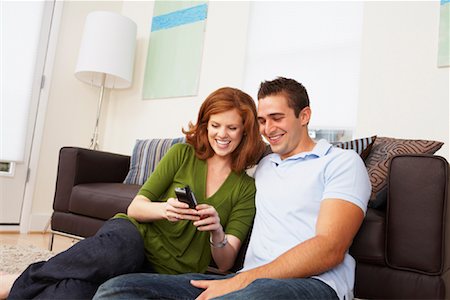 Couple in Living Room with Electronic Organizer Foto de stock - Con derechos protegidos, Código: 700-01787651