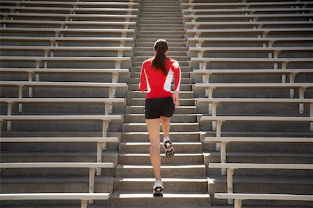 simsearch:700-01828744,k - Woman Jogging up Bleacher Steps Foto de stock - Con derechos protegidos, Código: 700-01828742