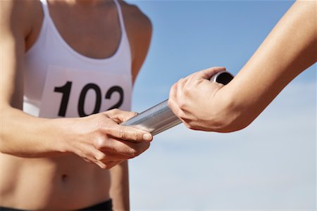 simsearch:700-00067192,k - Athletes Passing a Relay Baton Stock Photo - Rights-Managed, Code: 700-01837292