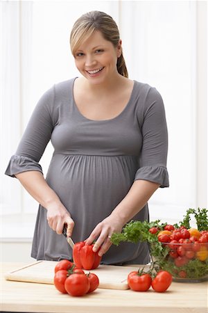 pregnant cooking - Pregnant Woman Slicing Vegetables Stock Photo - Rights-Managed, Code: 700-01837441