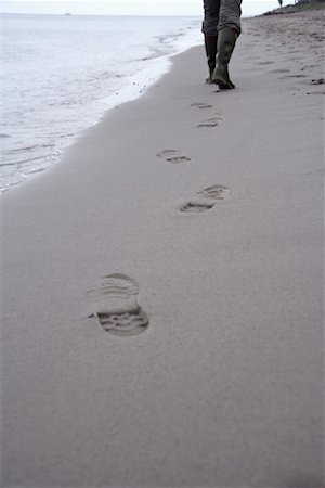 single footprint on the sand - Person in Rubber Boots Walking on Beach, Dahme, Schleswig-Holstein, Germany Foto de stock - Con derechos protegidos, Código: 700-01837846