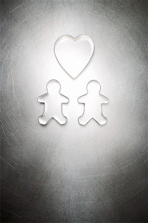 Two Gingerbread Men Cookie Cutters with Heart Shaped Cookie Cutter Stock Photo - Rights-Managed, Code: 700-01955415