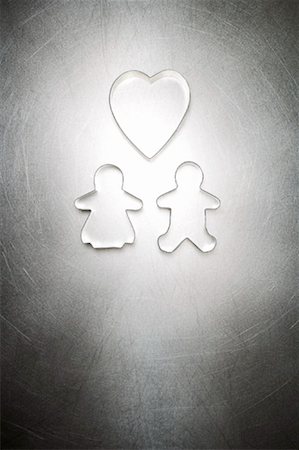 Gingerbread Man and Gingerbread Woman Cookie Cutter Couple with Heart Shaped Cookie Cutter Stock Photo - Rights-Managed, Code: 700-01955413