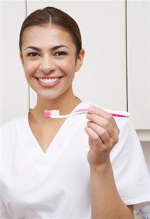 female dentist looking at camera - Portrait of Dentist with Toothbrush Stock Photo - Rights-Managed, Code: 700-01992979