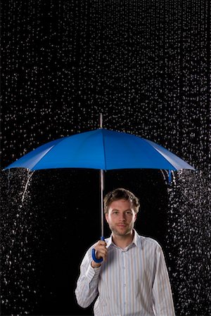 man standing in rain