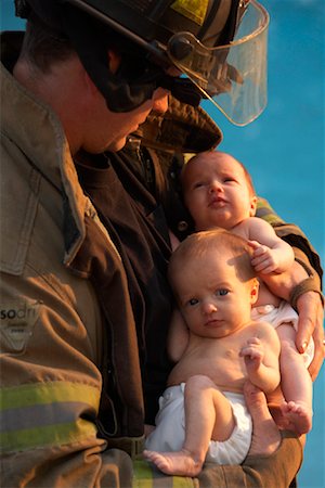 fireman and baby photo - Firefighter Holding Babies Stock Photo - Rights-Managed, Code: 700-02046362