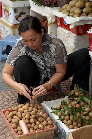 Woman Sorting Fruit at Market Stand, Ben Thanh Market, Ho Chi Minh City, Vietnam Stock Photo - Rights-Managed, Code: 700-02063649