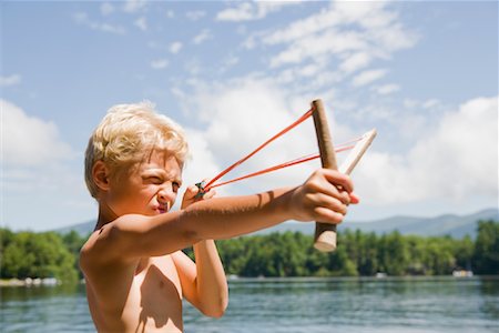 Boy Aiming with Slingshot Fotografie stock - Rights-Managed, Codice: 700-02071304