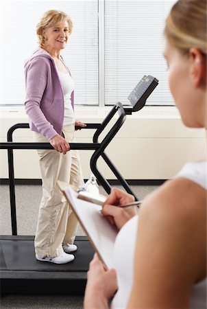 simsearch:649-06623114,k - Woman using Treadmill with Physiotherapist Checking Progress Stock Photo - Rights-Managed, Code: 700-02071768
