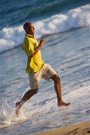 exercise black people water - Man Running on the Beach, Huntington Beach, Orange County, California, USA Foto de stock - Con derechos protegidos, Código: 700-02081958