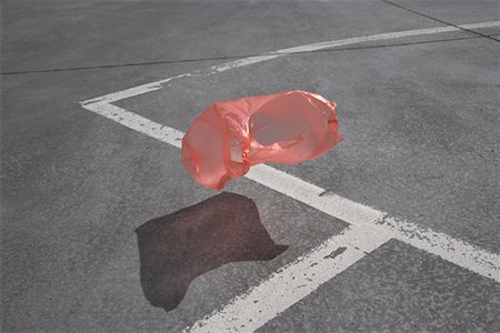 environmental pollution of garbage - Plastic Bag Floating in Parking Lot Stock Photo - Rights-Managed, Code: 700-02082061