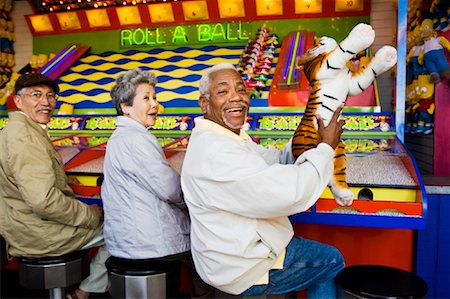 senior friends laughing - Seniors Playing Amusement Arcade Game at Santa Monica Pier, California, USA Stock Photo - Rights-Managed, Code: 700-02125380