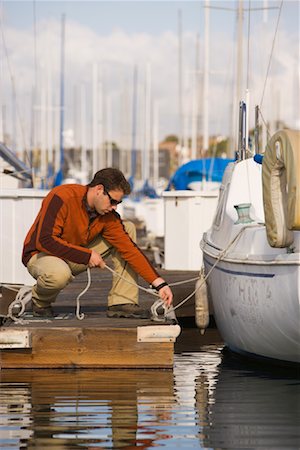 securing - Homme attachant voilier à quai dans le port de plaisance, Long Beach, Californie Photographie de stock - Rights-Managed, Code: 700-02125550