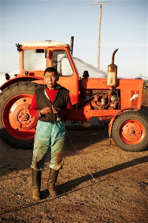 farmer pose full body - Portrait of Farmer by Tractor, Khustain Nuruu National Park, Mongolia Stock Photo - Rights-Managed, Code: 700-02156732