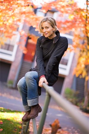 Woman Sitting on Railing Foto de stock - Con derechos protegidos, Código: 700-02176018