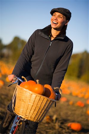 Woman Riding Bike in Pumpkin Patch Stock Photo - Rights-Managed, Code: 700-02176025