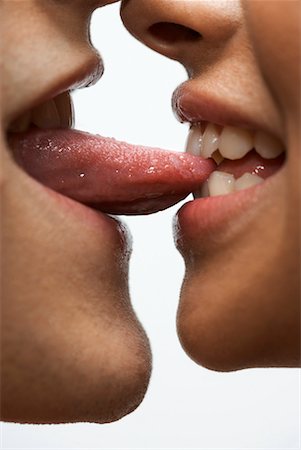 smiling lips - Woman Biting Man's Tongue Foto de stock - Con derechos protegidos, Código: 700-02200010