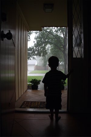 standing in the rain photography - Boy Looking Out of Doorway, Conroe, Texas, USA Stock Photo - Rights-Managed, Code: 700-02200609