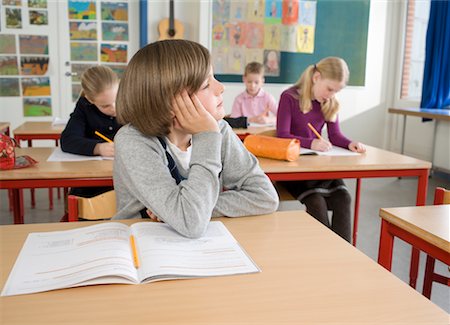 sans cession de droits - Garçon avec le travail scolaire en salle de classe Photographie de stock - Rights-Managed, Code: 700-02217467