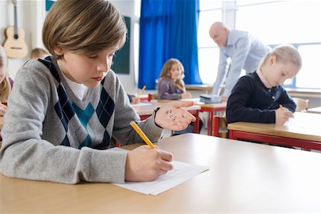 photo of class with misbehaving kids - Boy Cheating on Test Foto de stock - Con derechos protegidos, Código: 700-02217493