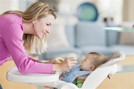 eating in chair side view - Mother Feeding Baby Stock Photo - Rights-Managed, Code: 700-02231907