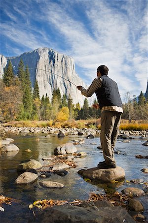 pesca con la mosca - Man Fishing in Merced River, Yosemite National Park, California, USA Fotografie stock - Rights-Managed, Codice: 700-02245507