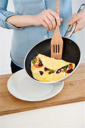 frying pan - Woman Frying Omelette Stock Photo - Rights-Managed, Code: 700-02264259