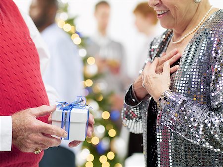 senior woman at christmas parties - Man Giving Christmas Present to Woman Stock Photo - Rights-Managed, Code: 700-02264279