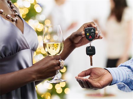 Couple at Christmas Party, Woman Giving Car Keys to Man Foto de stock - Con derechos protegidos, Código: 700-02264284