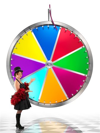 rotate wheel game - Woman Standing by Carnival Game Stock Photo - Rights-Managed, Code: 700-02265051