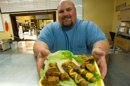 fat man with goatee - Man Serving Tray of Meat, Lafayette, Louisiana, USA Stock Photo - Rights-Managed, Code: 700-02265179