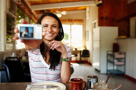 Woman in Restaurant with Digital Camera Stock Photo - Rights-Managed, Code: 700-02265384