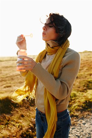 Woman Blowing Bubbles Outdoors Stock Photo - Rights-Managed, Code: 700-02265401