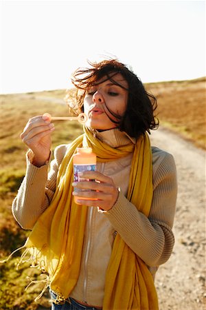 Woman Blowing Bubbles Outdoors Stock Photo - Rights-Managed, Code: 700-02265402