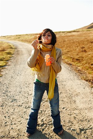 Woman Blowing Bubbles Outdoors Stock Photo - Rights-Managed, Code: 700-02265403